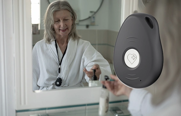 Senior wearing showerproof pendant alarm in shower