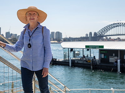 Active senior woman wearing LiveLife emergency button near Sydney Harbour