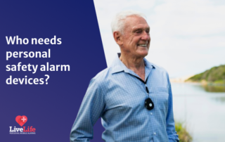 Older gentleman, smiling towards a picturesque view, wearing a black pendant alarm.