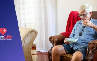 Senior in the home setting, sitting on the armchair, drinking water.