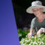 Senior lady gardening, wearing a livelife pendant.