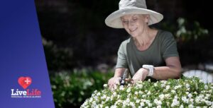 Lady gardening wearing her Live Life fall alarm pendant